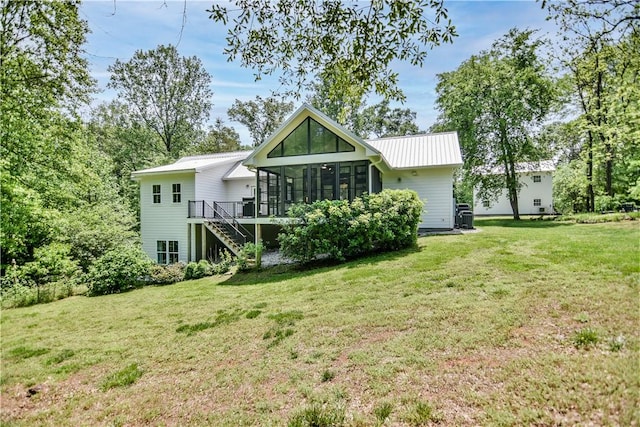 224 Edgewood Dr, Seneca, SC 29678 - back of house featuring a sunroom, stairway, a metal roof, and a yard