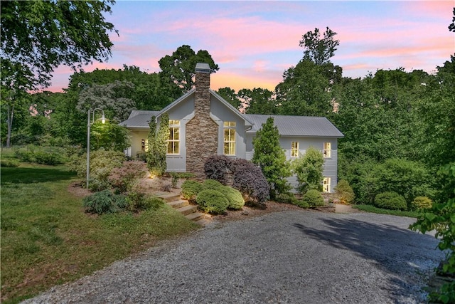 224 Edgewood Dr, Seneca, SC 29678 - view of front of house with a chimney, a metal roof, stone siding, and driveway