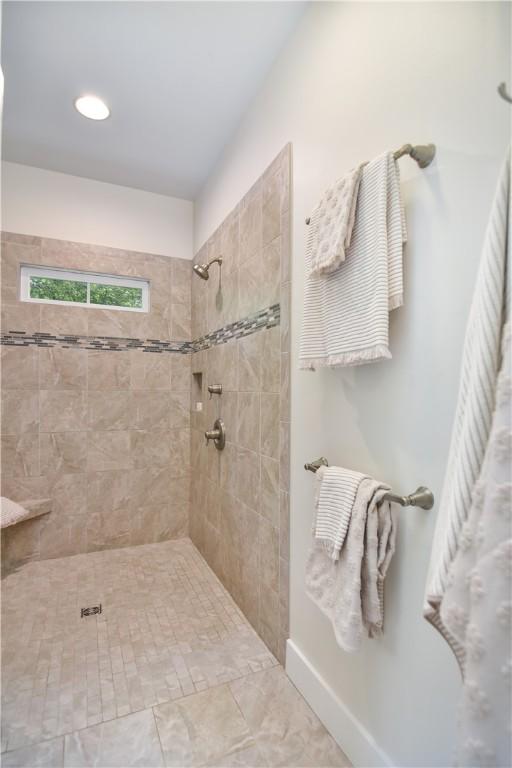 224 Edgewood Dr, Seneca, SC 29678 - bathroom featuring a tile shower and baseboards