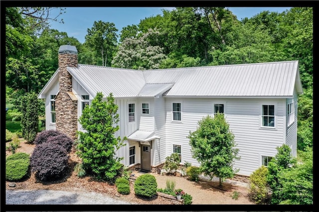 224 Edgewood Dr, Seneca, SC 29678 - view of front facade featuring board and batten siding, a chimney, and a metal roof
