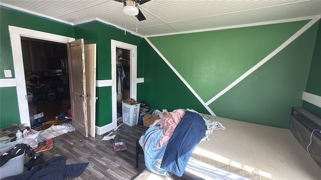 bedroom featuring wood finished floors, crown molding, and a ceiling fan