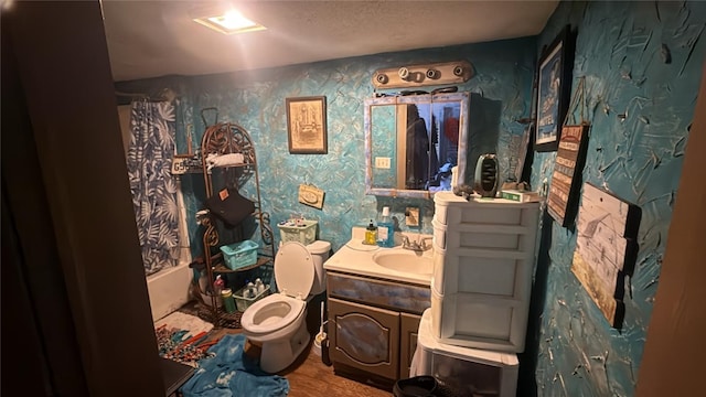bathroom featuring wallpapered walls, vanity, toilet, and shower / tub combo with curtain
