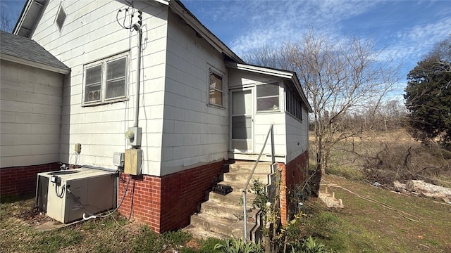 view of side of home featuring central AC unit
