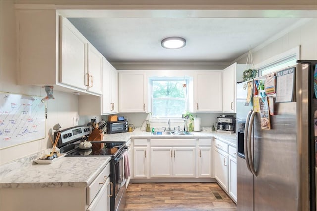 kitchen with stainless steel appliances, a sink, crown molding, white cabinets, and light countertops