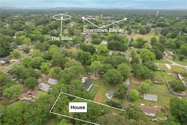 aerial view of property and surrounding area with property parcel outlined and a forest