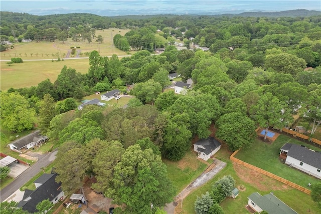 view of property location featuring a forest