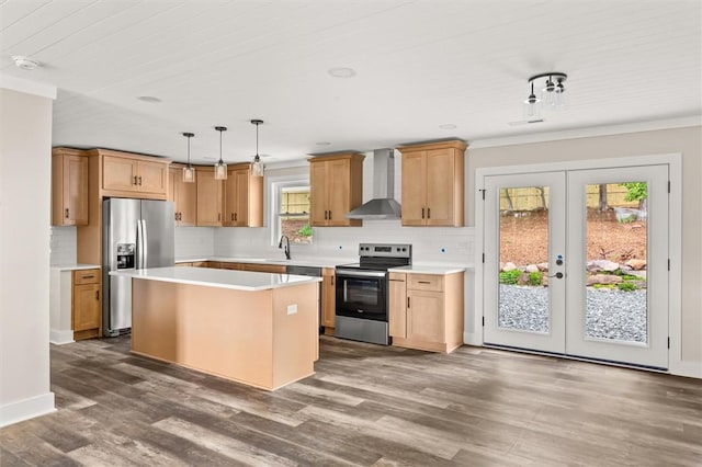 101 Fairview Dr, Greenville, SC 29609 - kitchen featuring appliances with stainless steel finishes, wall chimney exhaust hood, light countertops, decorative backsplash, and a center island