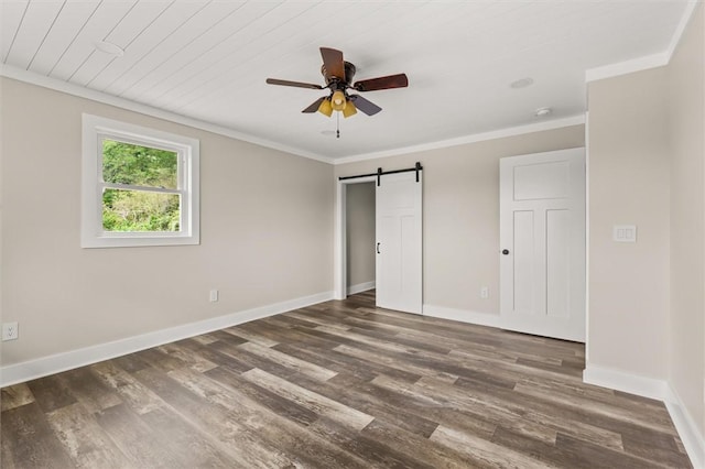 101 Fairview Dr, Greenville, SC 29609 - unfurnished bedroom featuring a barn door, wood finished floors, baseboards, and ornamental molding