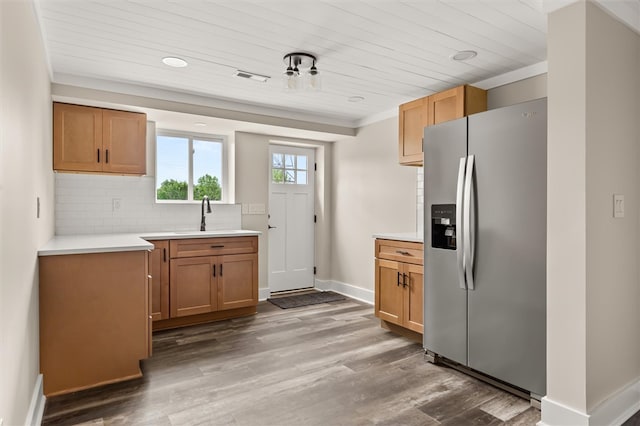 101 Fairview Dr, Greenville, SC 29609 - kitchen with stainless steel fridge, a sink, decorative backsplash, wood finished floors, and baseboards