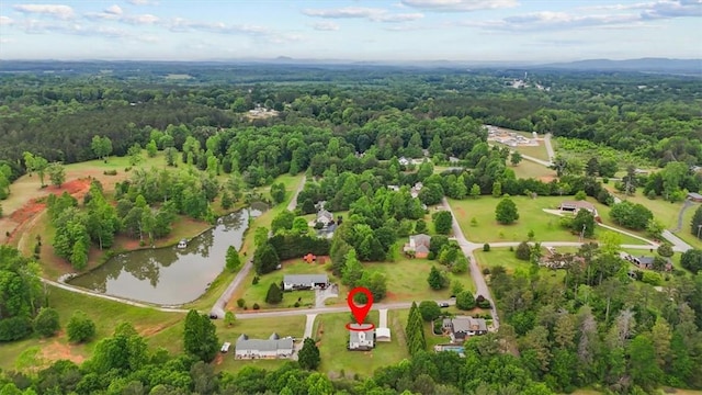 bird's eye view of a heavily wooded area and a large body of water