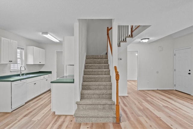 staircase with wood finished floors and baseboards