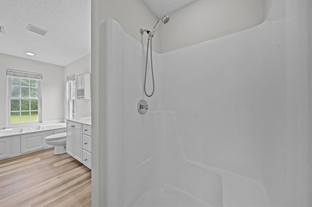full bath with a shower, vanity, wood finished floors, and toilet