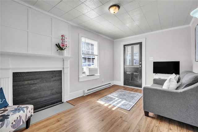 60 N Humphrey St, Inman, SC 29349 - living area featuring baseboard heating, crown molding, a fireplace with flush hearth, wood finished floors, and baseboards