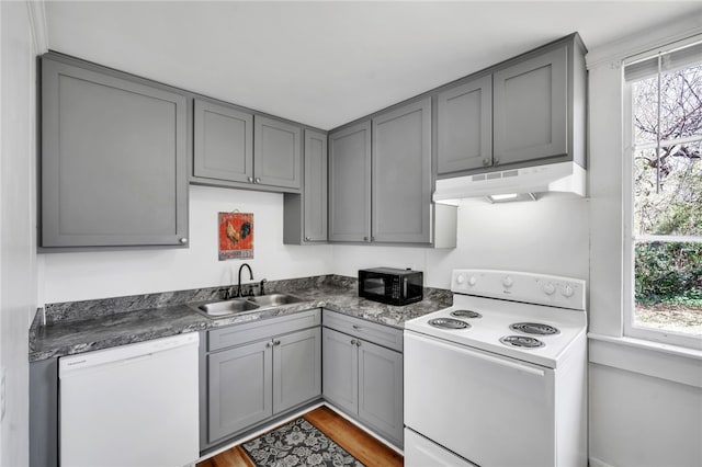 60 N Humphrey St, Inman, SC 29349 - kitchen with under cabinet range hood, white appliances, gray cabinetry, a sink, and dark countertops