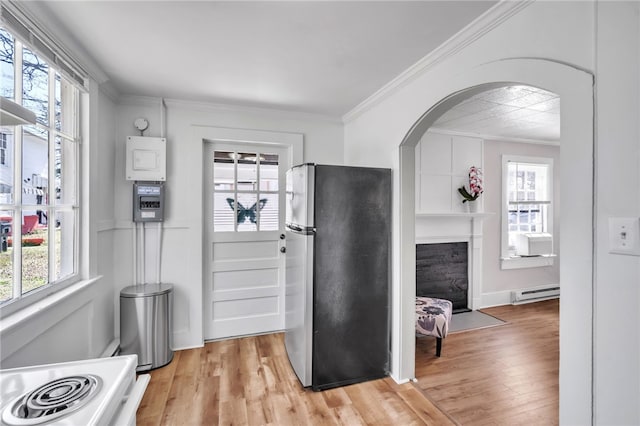 60 N Humphrey St, Inman, SC 29349 - kitchen featuring freestanding refrigerator, baseboard heating, range with electric cooktop, arched walkways, and healthy amount of natural light