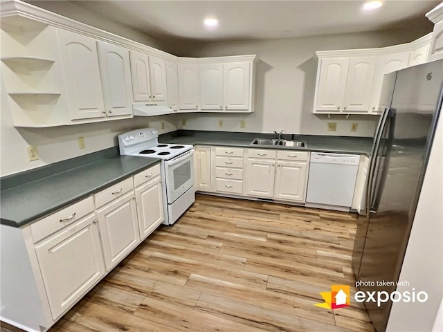 2153 Shea Ln, Seneca, SC 29672 - kitchen with white appliances, under cabinet range hood, a sink, dark countertops, and recessed lighting