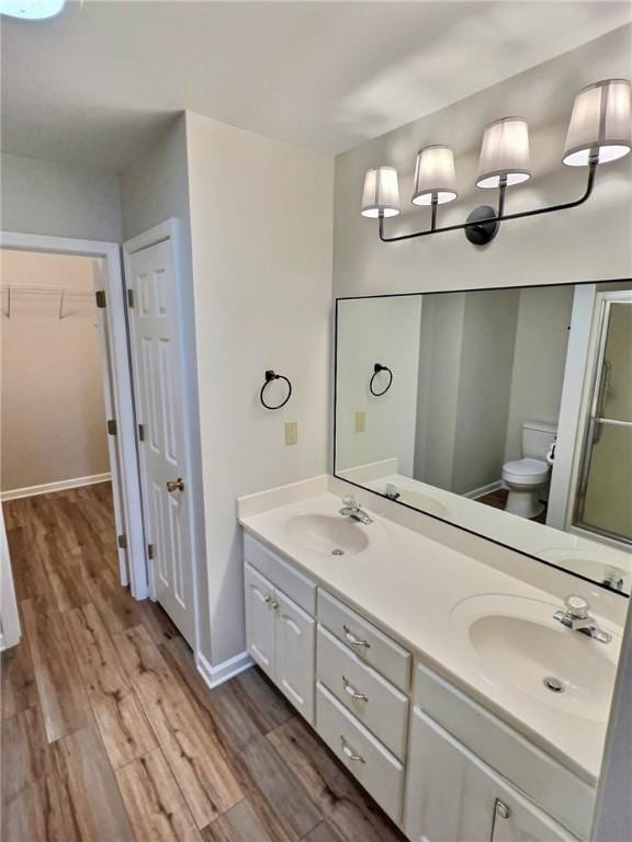 2153 Shea Ln, Seneca, SC 29672 - full bath featuring wood finished floors, double vanity, toilet, and a walk in closet