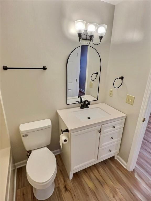2153 Shea Ln, Seneca, SC 29672 - bathroom with wood finished floors, baseboards, toilet, vanity, and a chandelier