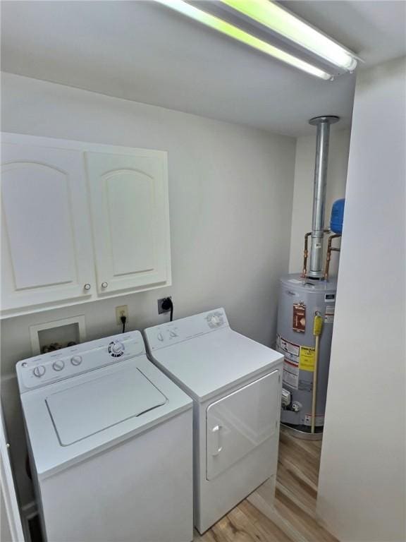 2153 Shea Ln, Seneca, SC 29672 - laundry area with gas water heater, washer and clothes dryer, cabinet space, and light wood-style floors