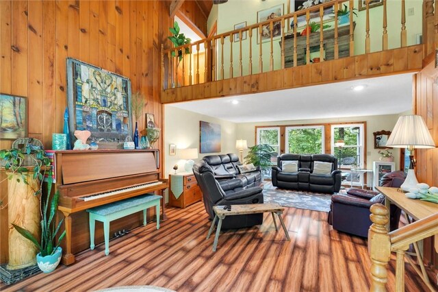 220 Family Dr, Seneca, SC 29678 - living area featuring a towering ceiling, wood walls, and wood finished floors
