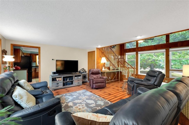 220 Family Dr, Seneca, SC 29678 - living room with stairs, wood finished floors, and a textured ceiling