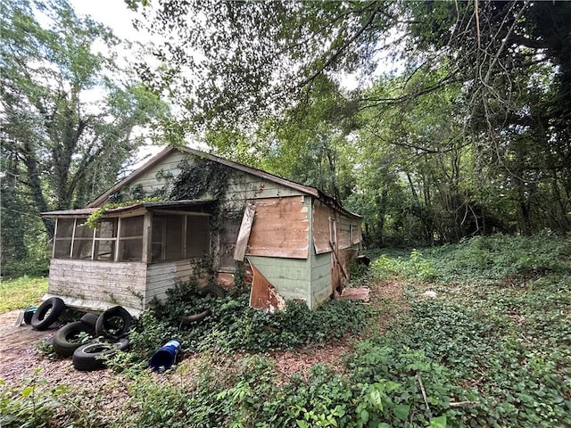 view of outbuilding with a sunroom