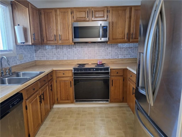 407 Northlake Dr, Anderson, SC 29625 - kitchen with appliances with stainless steel finishes, a sink, brown cabinetry, and light countertops