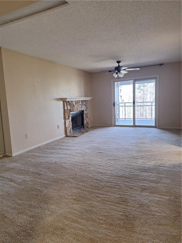 407 Northlake Dr, Anderson, SC 29625 - unfurnished living room with carpet floors, a stone fireplace, ceiling fan, a textured ceiling, and baseboards