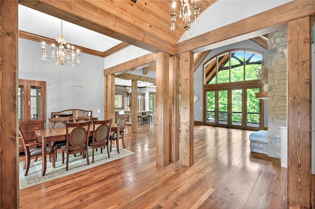 503 Greystoke Cv, Seneca, SC 29678 - dining space featuring a chandelier, high vaulted ceiling, wood-type flooring, and ornate columns