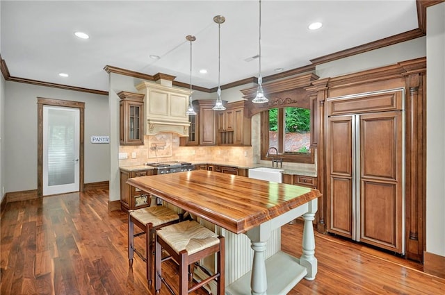 503 Greystoke Cv, Seneca, SC 29678 - kitchen featuring a sink, wood counters, baseboards, glass insert cabinets, and tasteful backsplash