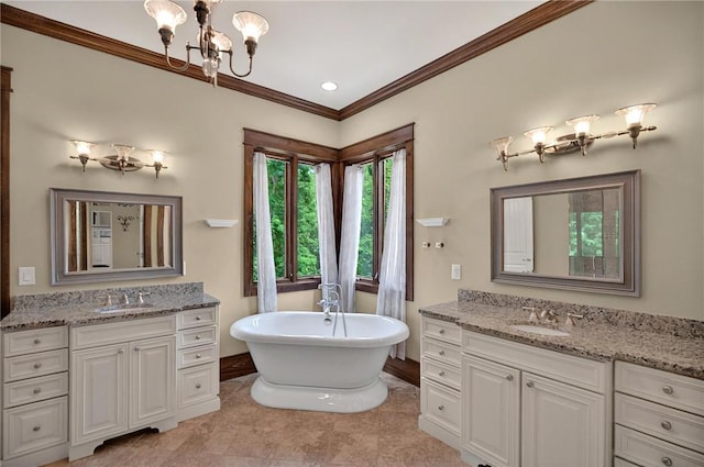 503 Greystoke Cv, Seneca, SC 29678 - bathroom with a chandelier, a freestanding tub, two vanities, crown molding, and baseboards