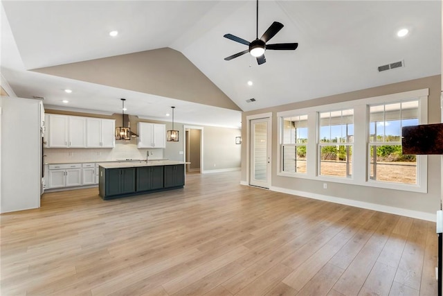 1004 Gaineswood Rd, Anderson, SC 29625 - unfurnished living room with ceiling fan, high vaulted ceiling, recessed lighting, light wood-style floors, and baseboards
