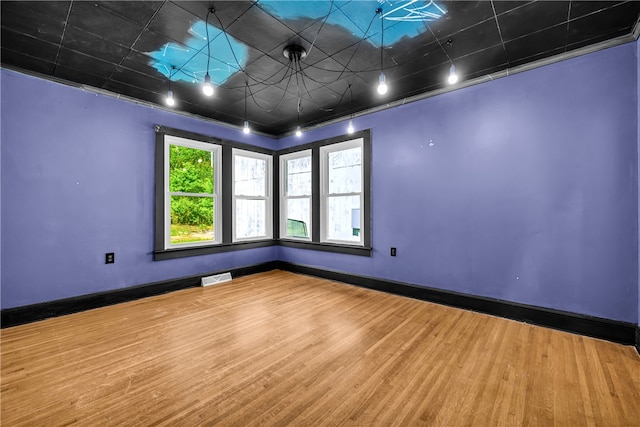 empty room with wood finished floors and baseboards