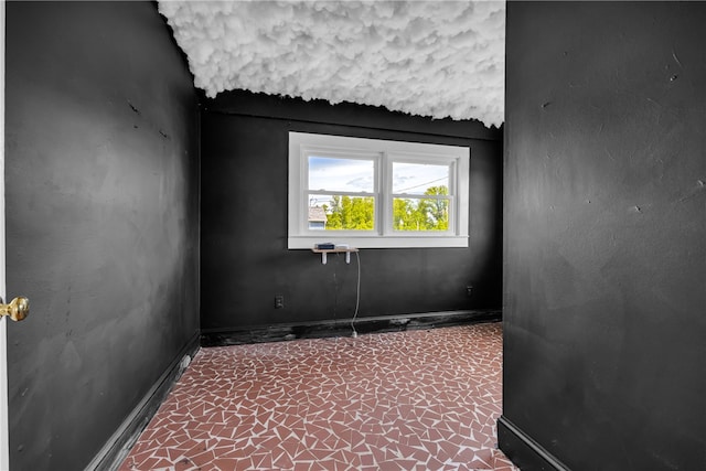 empty room featuring baseboards