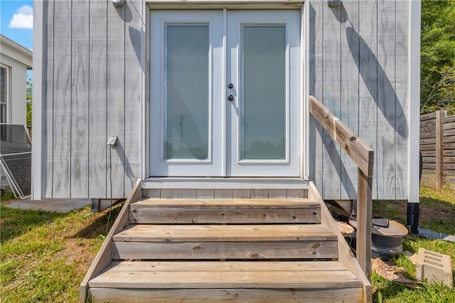 doorway to property featuring french doors and fence