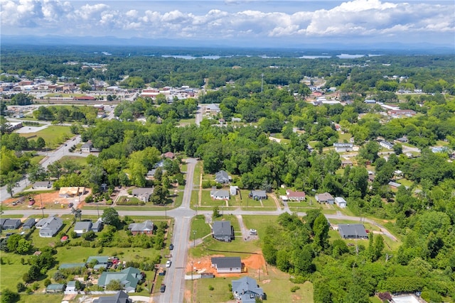 aerial view of property and surrounding area featuring nearby suburban area