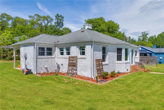 view of side of property featuring brick siding, a lawn, a chimney, and roof with shingles