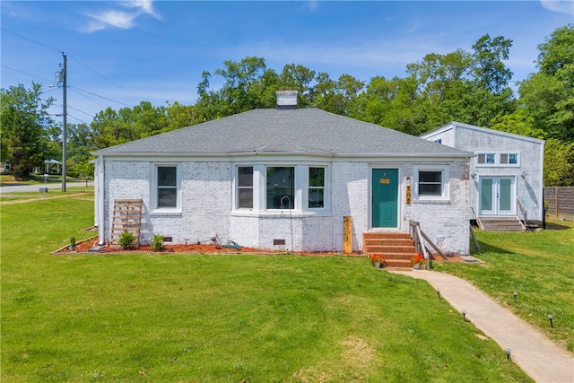 view of front of property with entry steps, brick siding, a front lawn, crawl space, and a chimney