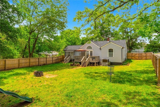 back of property featuring an outdoor fire pit, a deck, stairs, and a chimney