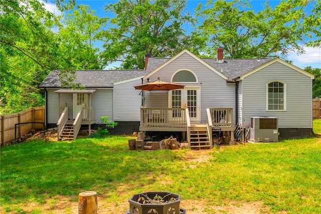 rear view of property with cooling unit, a deck, a shingled roof, and crawl space