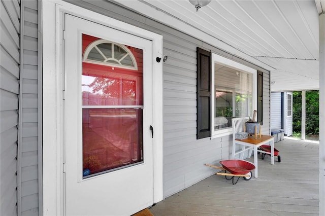view of exterior entry with covered porch