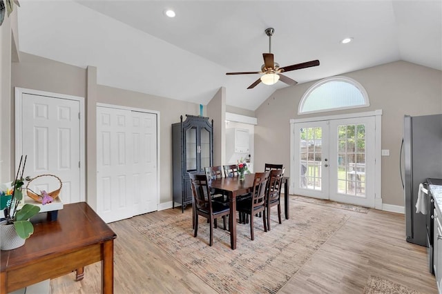 dining area with french doors, lofted ceiling, a ceiling fan, light wood-style floors, and baseboards