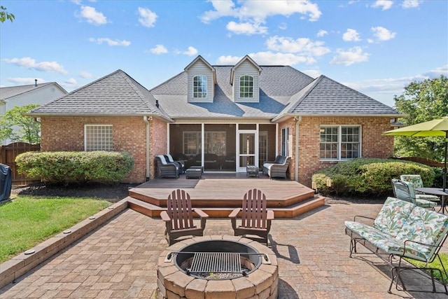 110 Red Maple Cir, Easley, SC 29642 - rear view of house with a fire pit, brick siding, a wooden deck, and a sunroom
