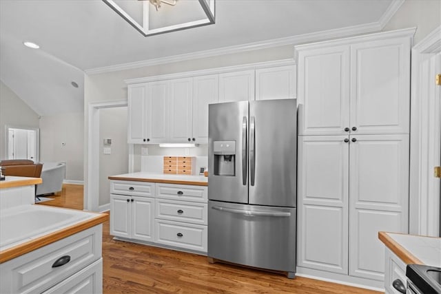 110 Red Maple Cir, Easley, SC 29642 - kitchen with stainless steel fridge, light countertops, white cabinetry, wood finished floors, and crown molding