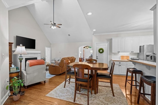 110 Red Maple Cir, Easley, SC 29642 - dining room featuring ceiling fan, light wood-type flooring, a fireplace, arched walkways, and recessed lighting