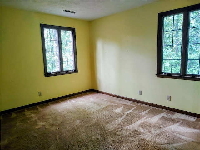 carpeted empty room with baseboards
