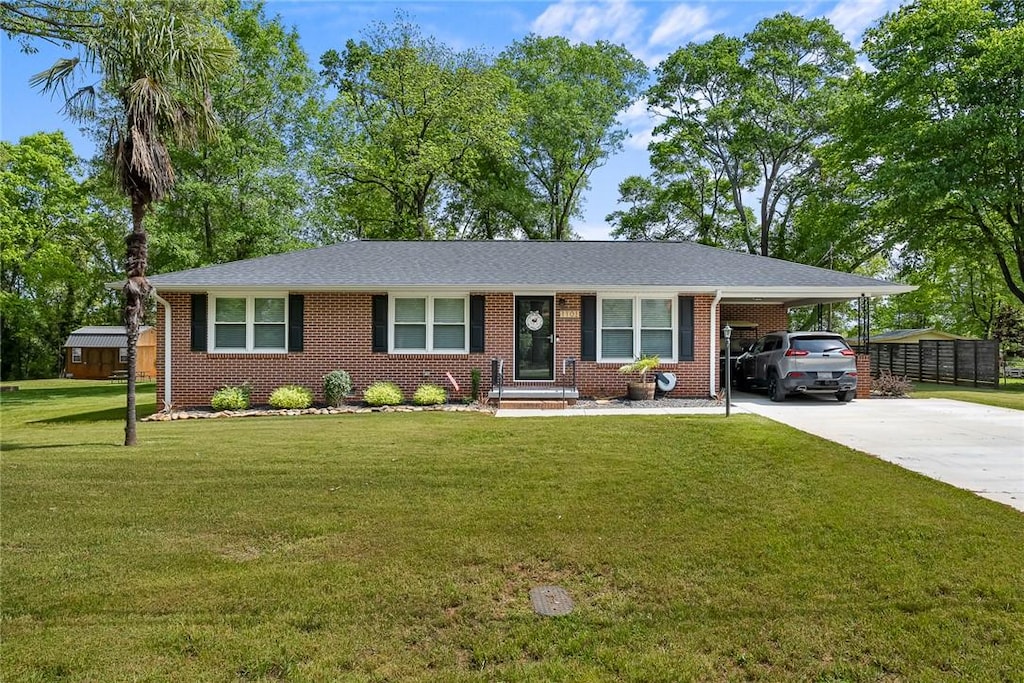 1101 Oak Dr, Pendleton, SC 29670 - ranch-style house featuring an attached carport, concrete driveway, brick siding, and a front yard
