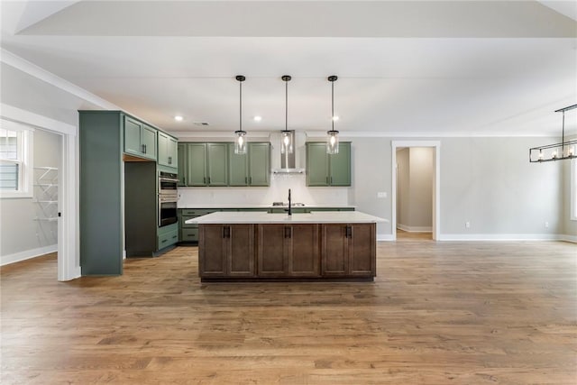 327 Thompson Rd, Taylors, SC 29687 - kitchen with green cabinets, wall chimney range hood, baseboards, light countertops, and recessed lighting
