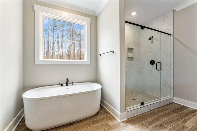 327 Thompson Rd, Taylors, SC 29687 - bathroom with wood tiled floors, baseboards, a marble finish shower, and a freestanding tub