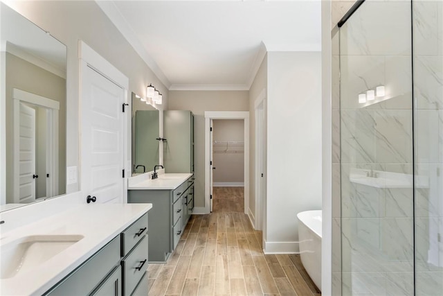 327 Thompson Rd, Taylors, SC 29687 - bathroom with a freestanding tub, tiled shower, crown molding, two vanities, and wood finished floors